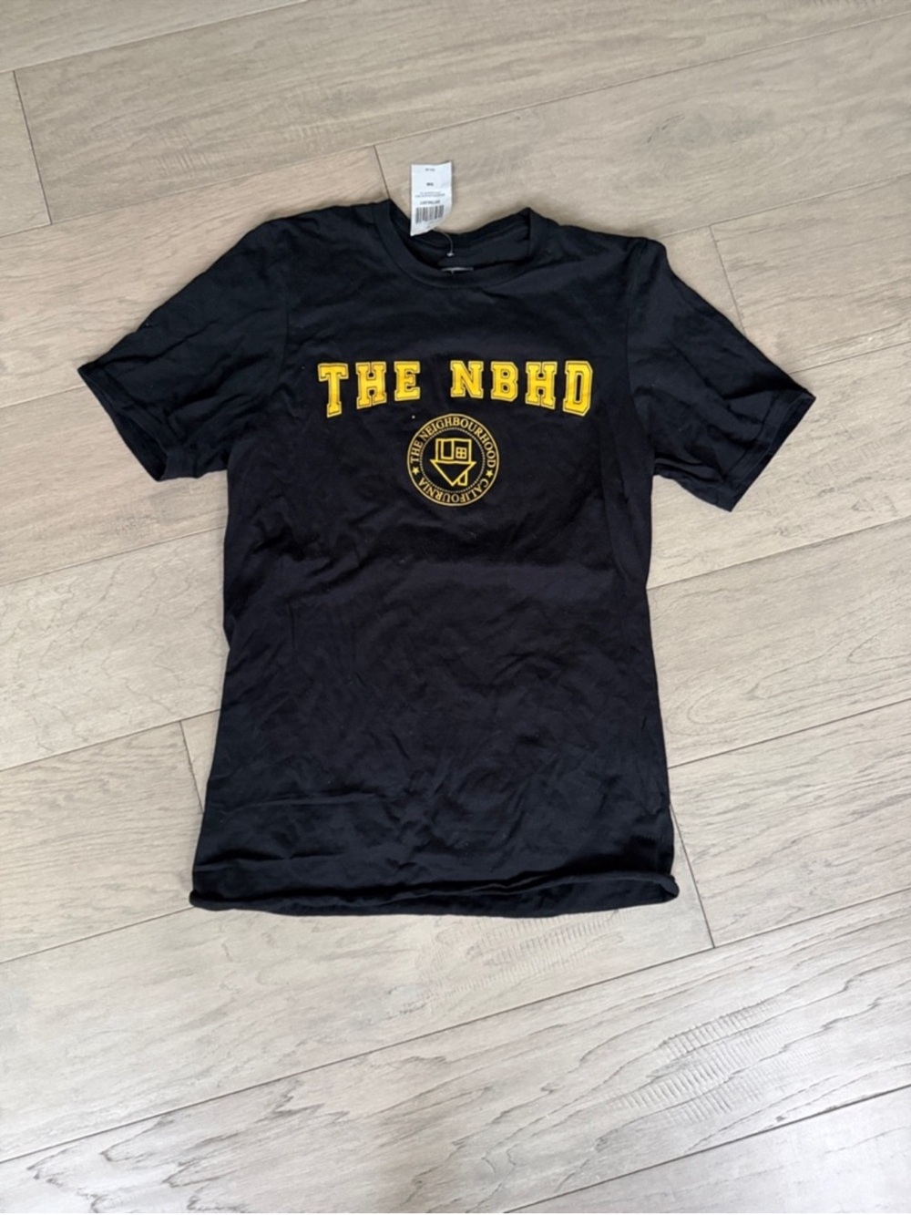 The NBHD Black Graphic Tee with Yellow Logo